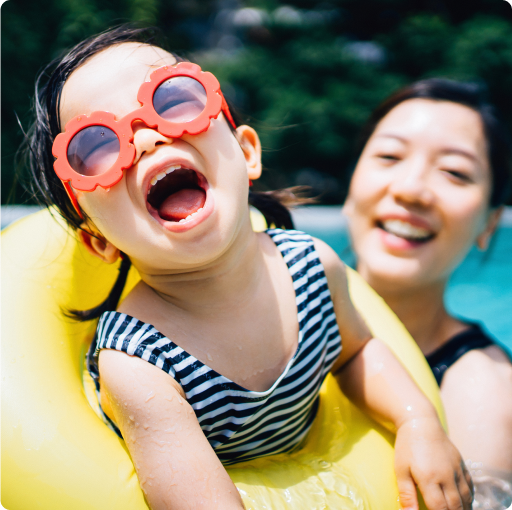 Woman and child in pool, smiling