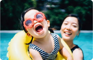 Woman and child in pool, smiling